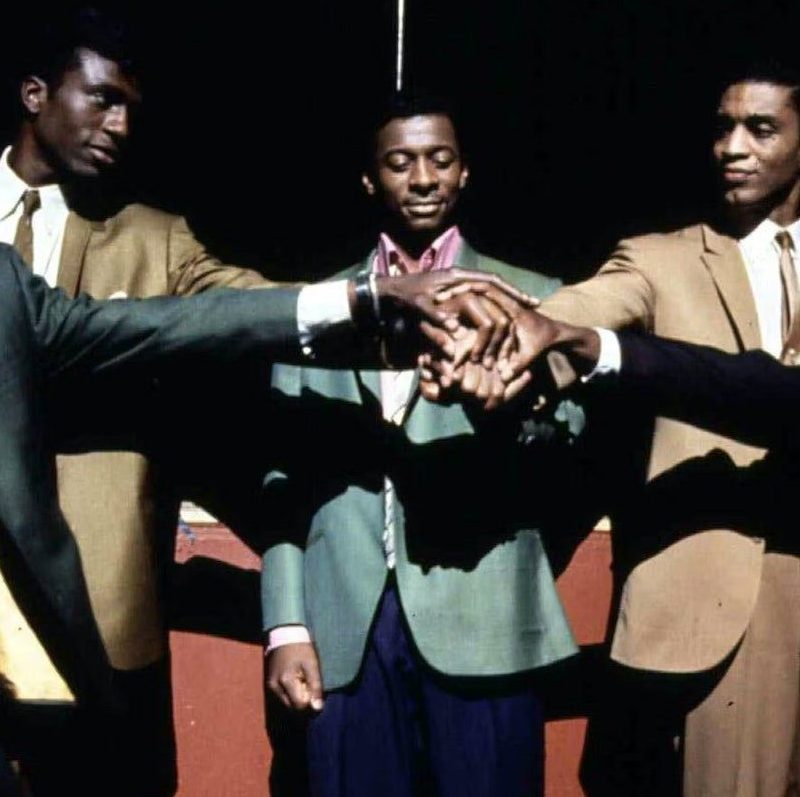 The Five Heartbeats standing on stage together.